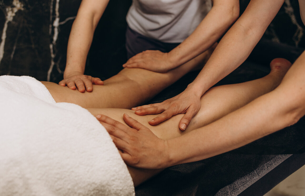 Four hands massage with two therapists working on one client