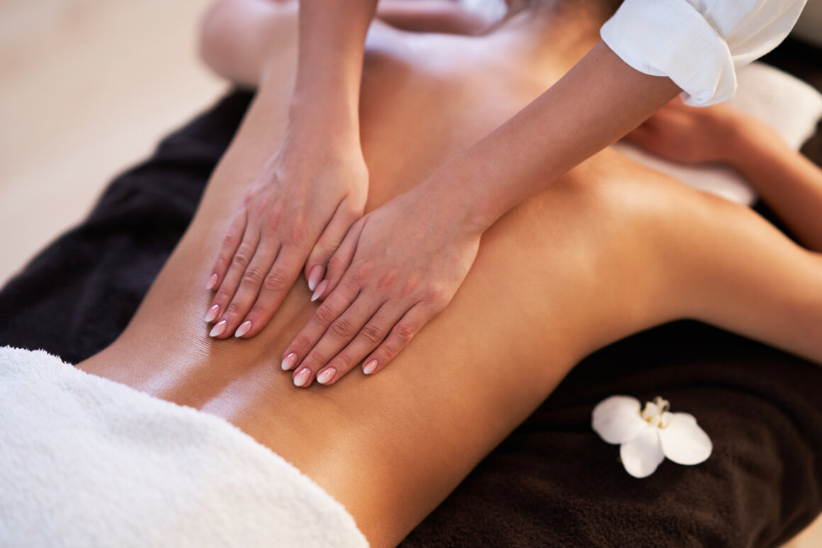 Therapist working on a client’s calf muscle for sports recovery